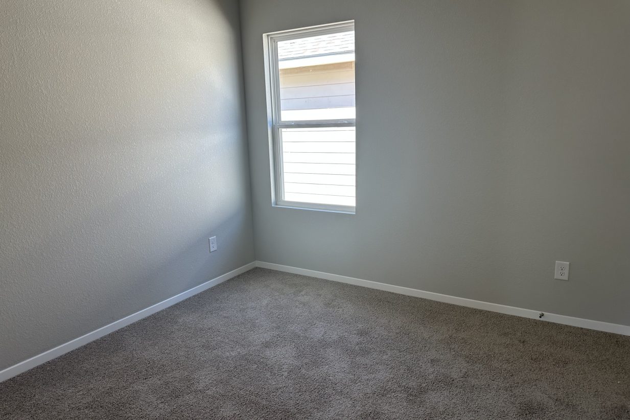 Image of bedroom with window and carpet