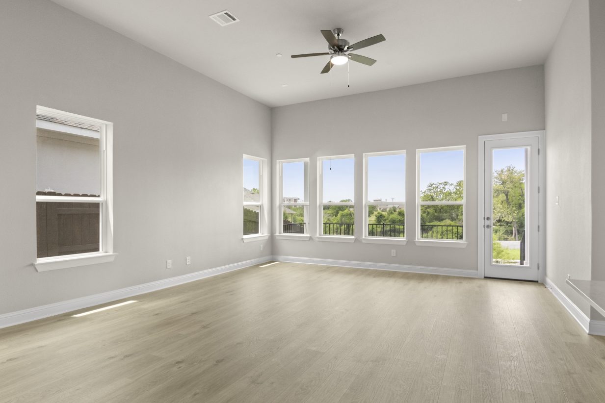 View of living room with five windows and glass back door